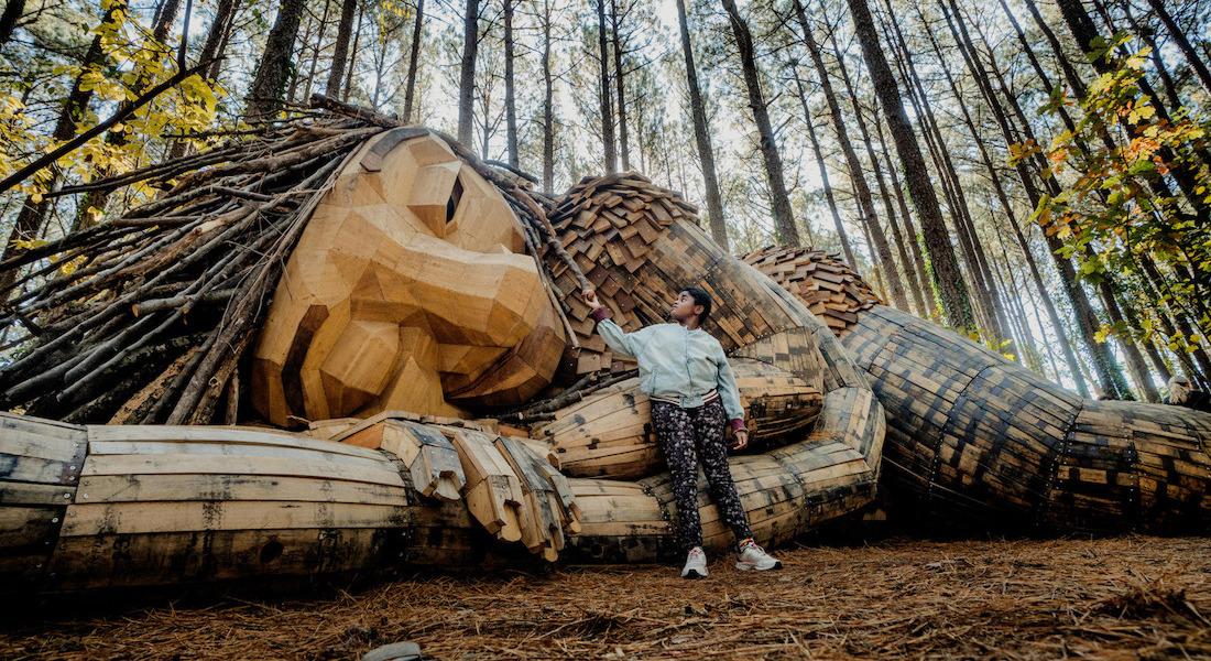 Posing in front of sleeping troll on Troll Trek, Dix Park Conservancy, Raleigh NC