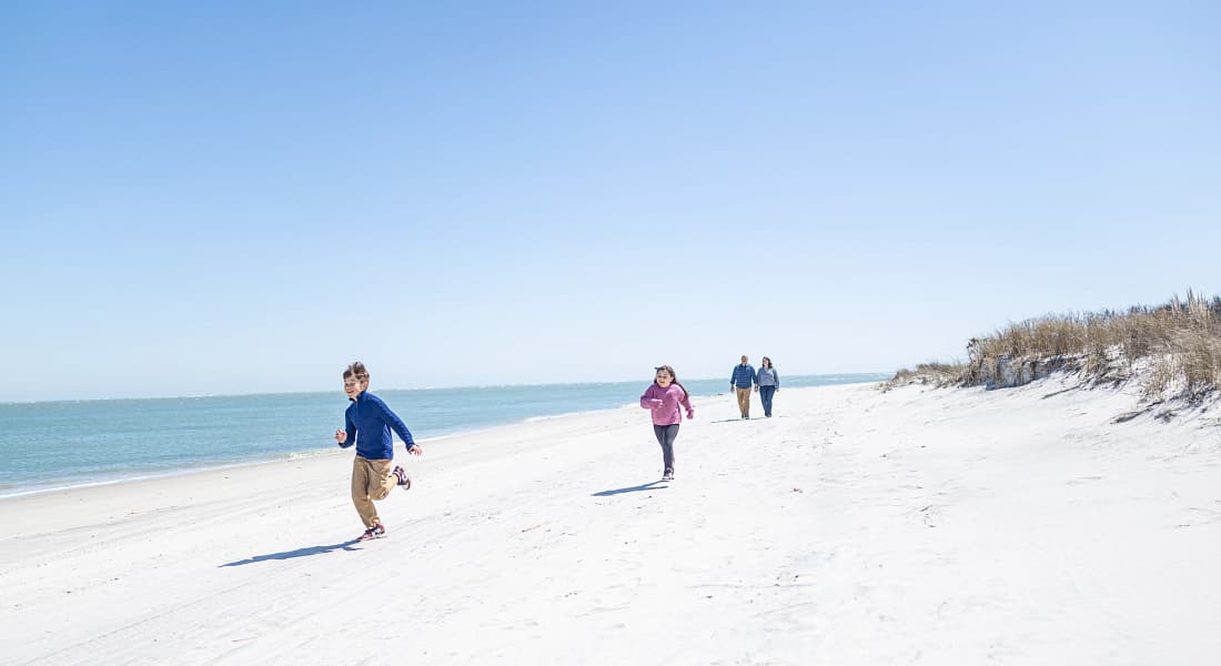 Family taking a walk at Topsail Beach, North Carolina