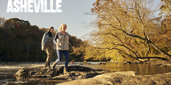 Two women hiking along the French Broad river in Asheville, NC.
