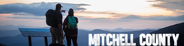 A couple overlooks some of the highest peaks in the east in Mitchell County, NC.