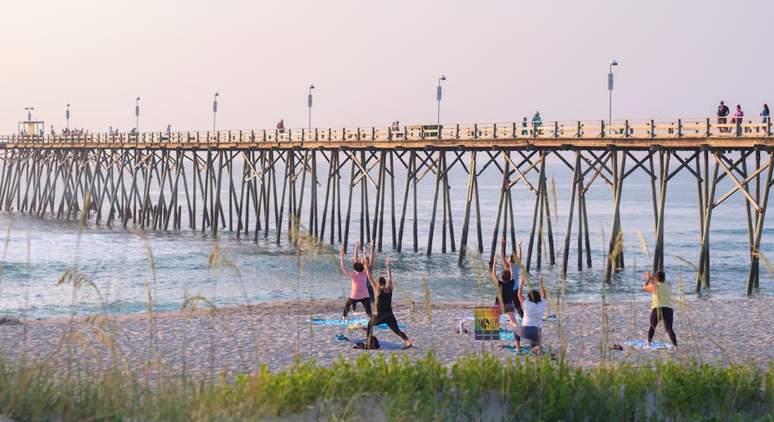 Beach yoga by Kure Beach Pier, Wilmington, NC