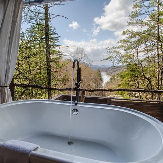 Soaking tub at Lakeview at Fontana, surrounded by views of the Great Smoky Mountains and Fontana Lake