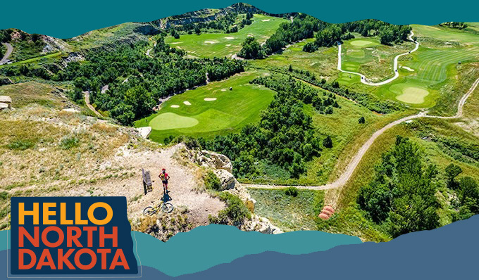 Aerial view of a bicyclists on a cliff over looking a golf course