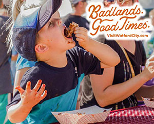A little boy eating messy ribs