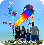 Family of four flying a colorful kite
