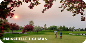 Man and boy on the green of a golf course