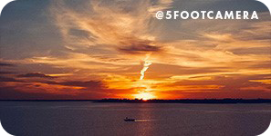 A bright orange sunset over a body of water, with overlay text that reads: @5footcamera