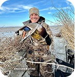Smiling man holding a hunted bird