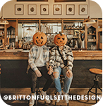 Two people sitting on stools at a bar with jack-o-lanterns on their heads, with overlay text that reads: @brittonfuglsetthedesign