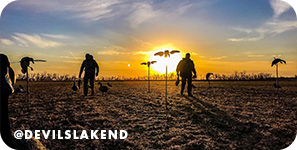 Silhouette of people walking through a field at sunset, with overlay text that reads: @devilslakend
