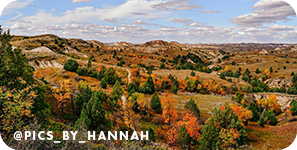 Panoramic view of rock formations and green and orange trees, with overlay text that reads: @pics_by_hannah
