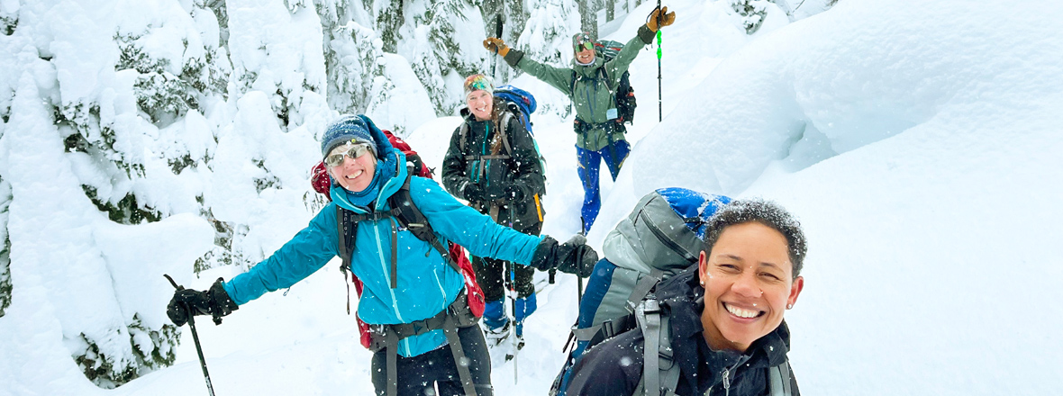 A group of skiers smiling at the camera.