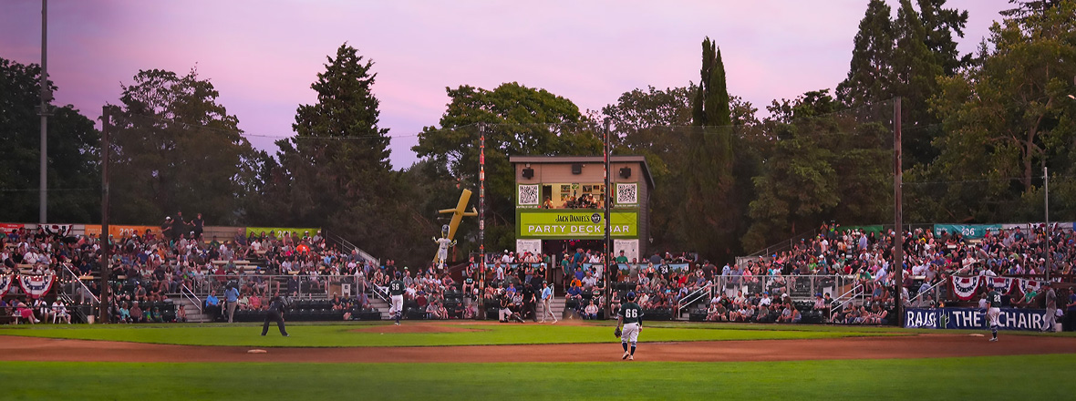 A baseball stadium filled with fans and players on the field.