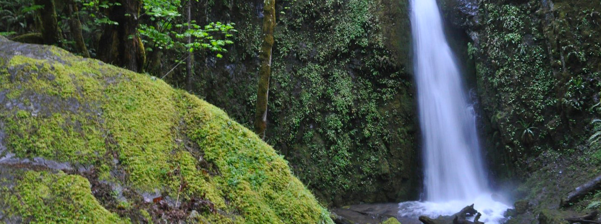 A waterfall flows onto rocks.