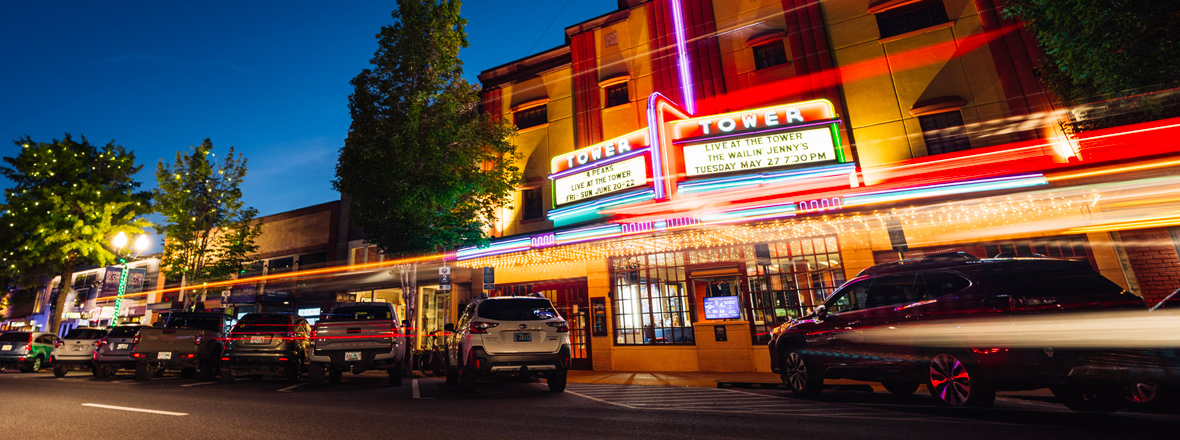Exterior building and marquee theater sign with current shows.