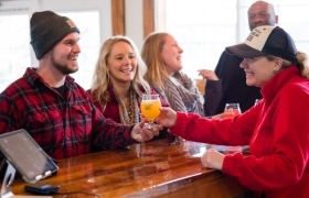 Group of friends enjoying drinks at a casual craft brewery.