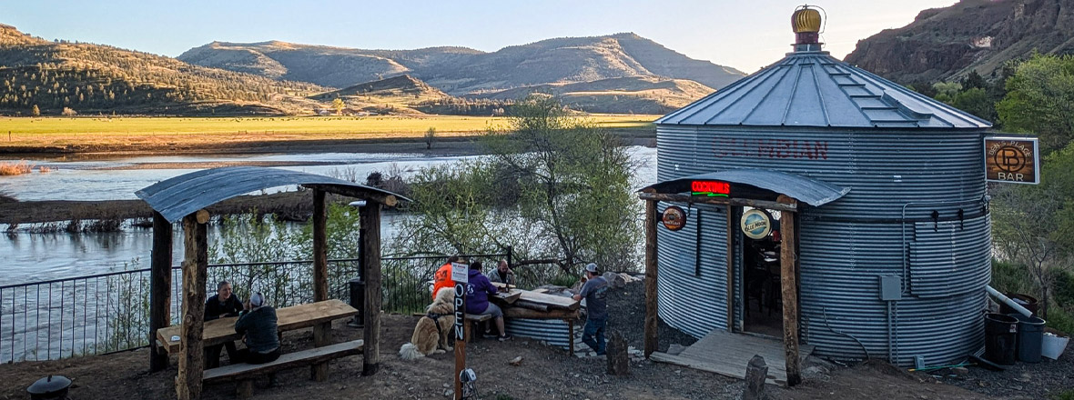 A former silo is a now a bar alongside a river.