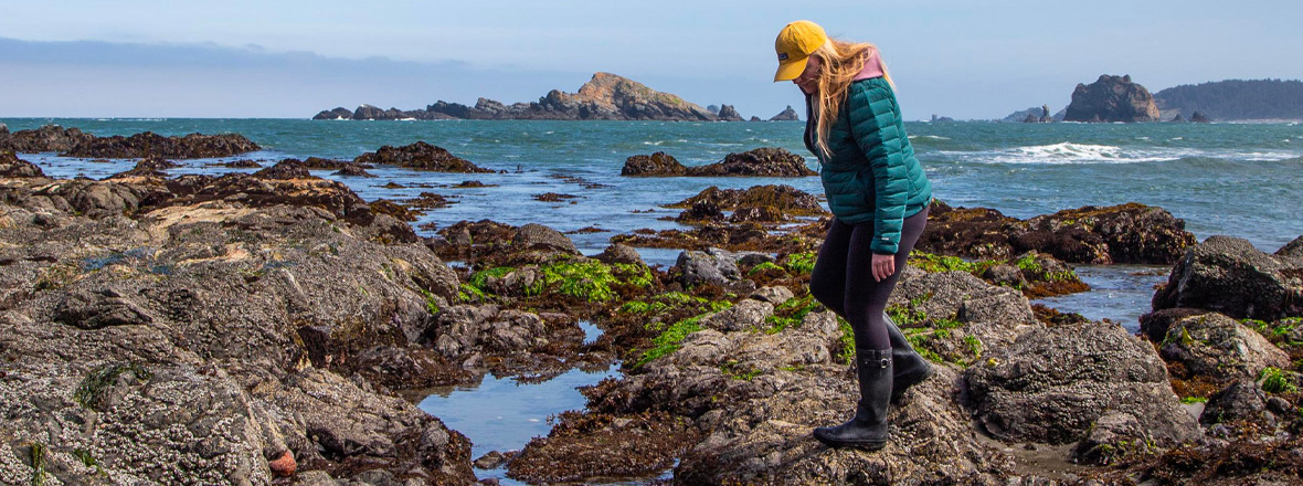 A woman looking into tide pools.
