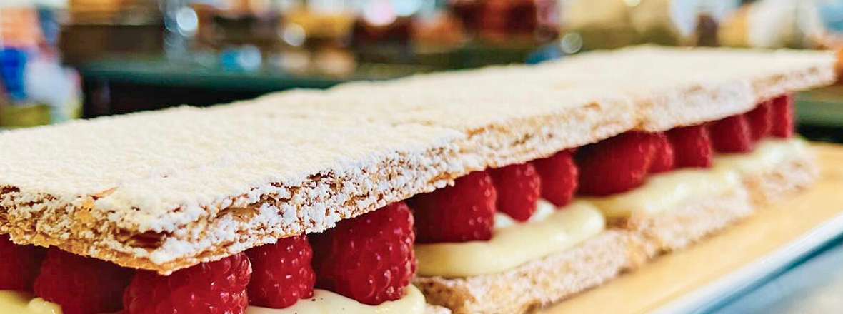Long pastry with raspberries and cream filling.