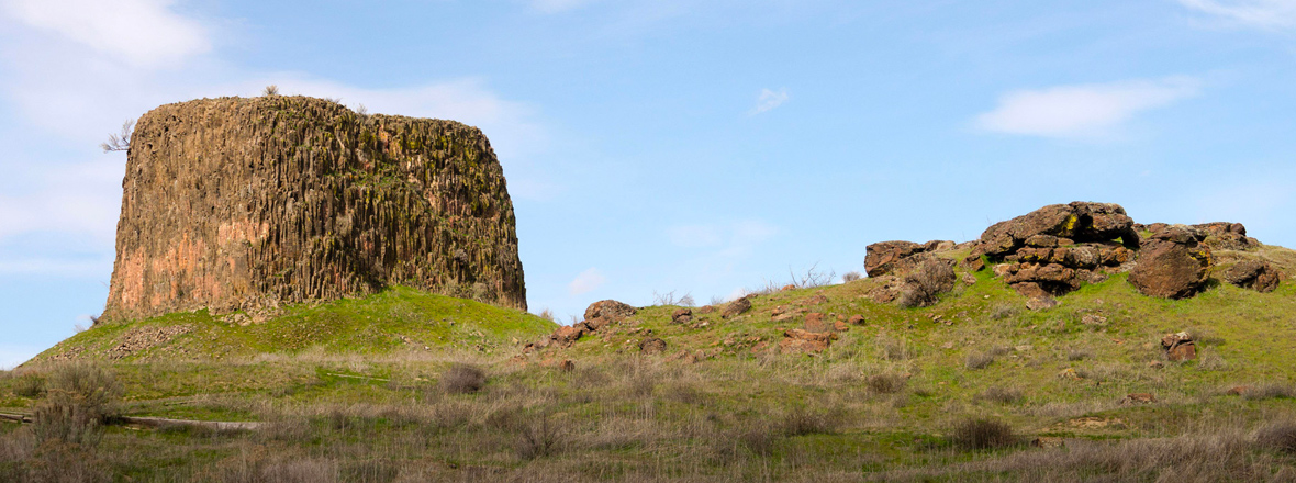 A large rectangular rock formation jutting out of a hillside.