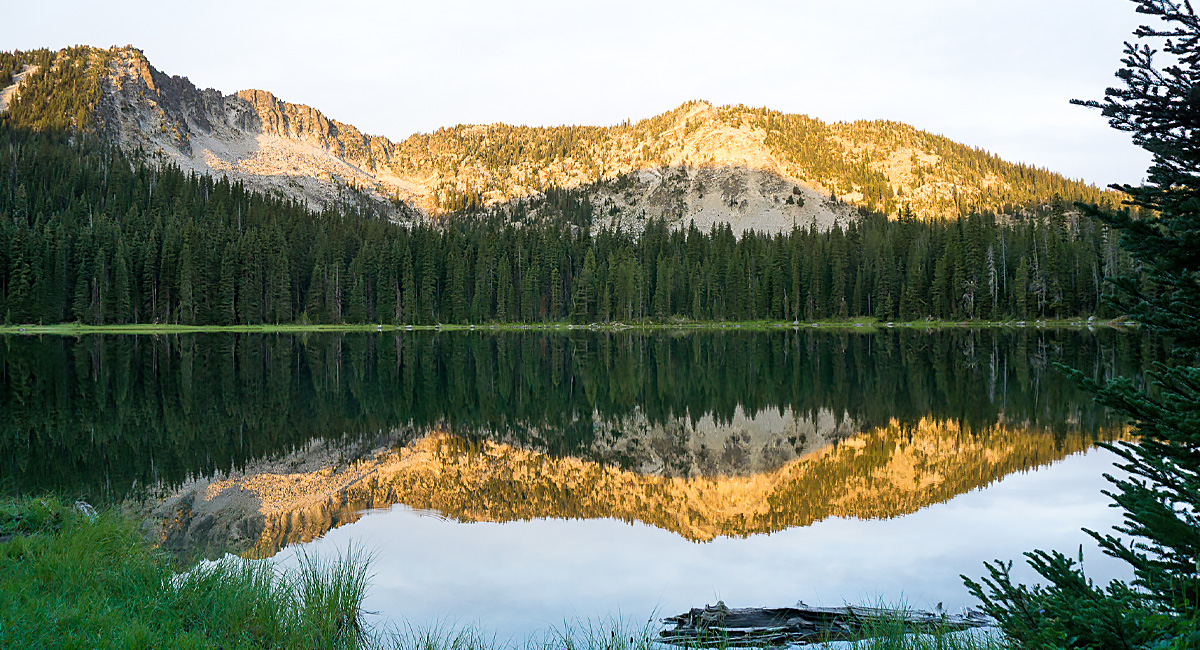 Mountains reflect in a lake.