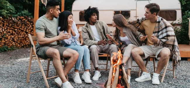 Imag eof friends around campire telling horror stories