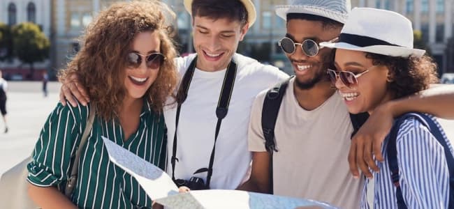 Friends on vacation looking at guide