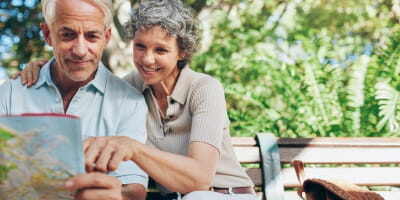 Senior couple traveling looking at map