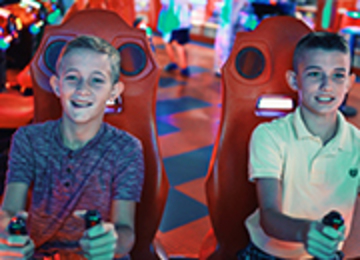 Kids playing arcade game