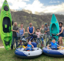 Group of people standing in front of a canoe