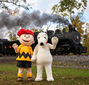 Young boy and dog mascots waving
