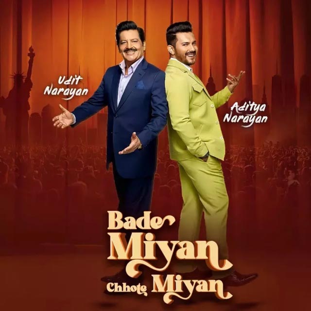 Udit Narayan and Aditya Narayan posing in front of a curtain.