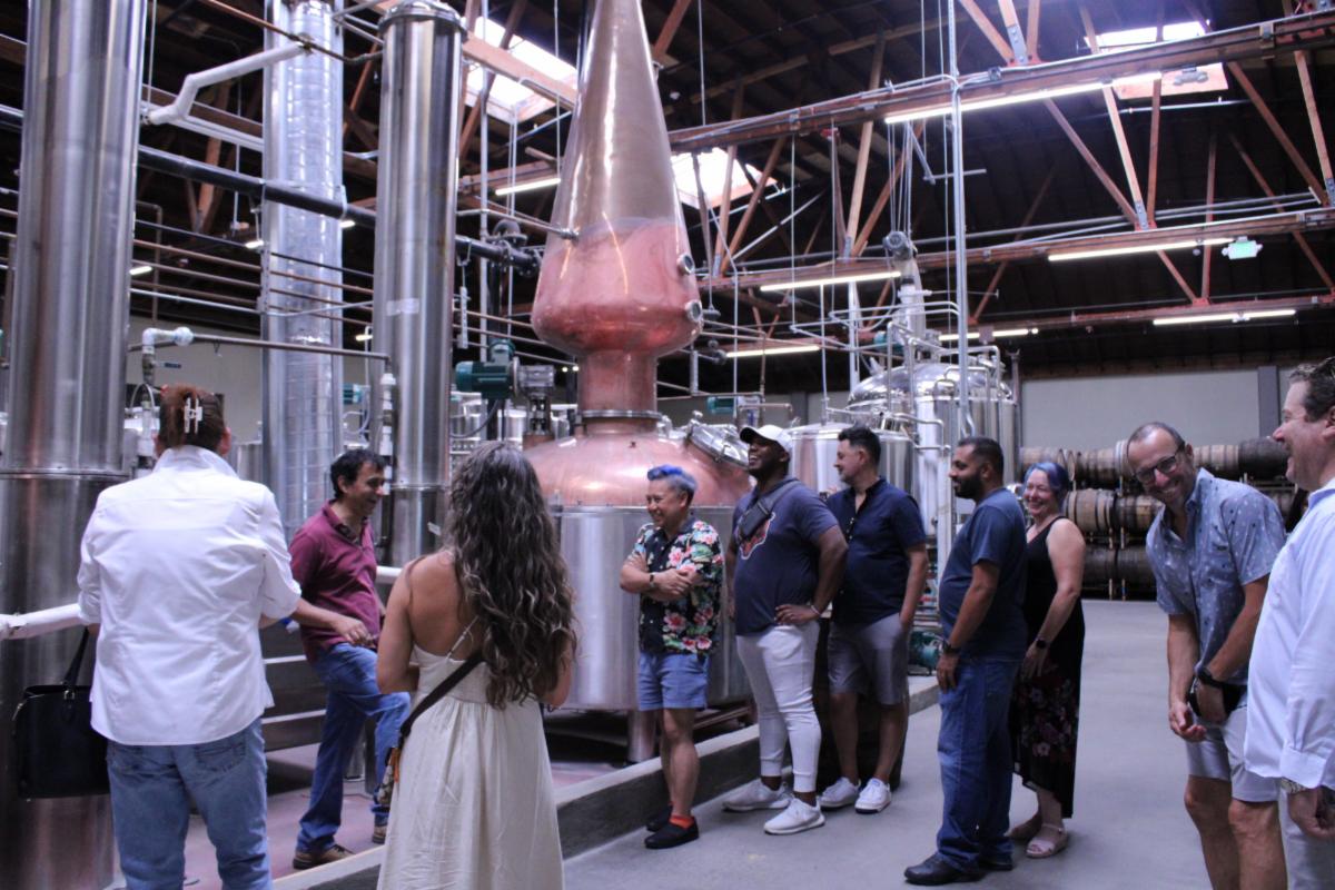 A group of people taking a tour of the 10th Street Distillery.