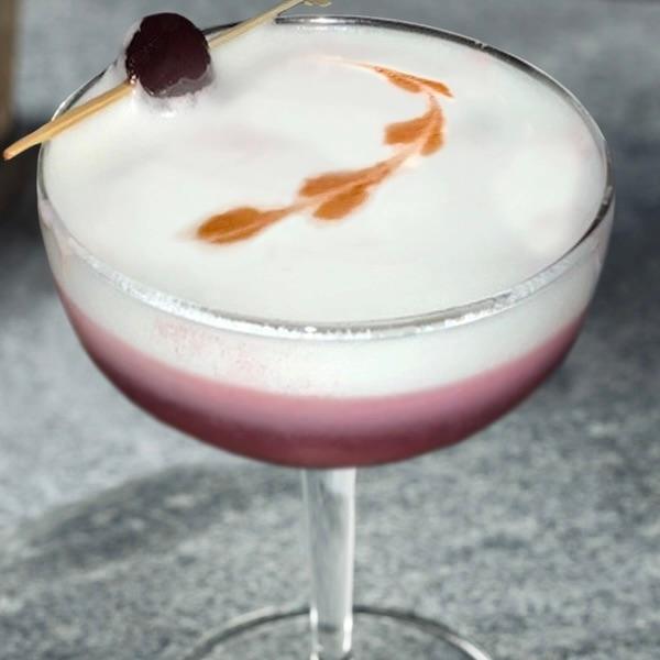 A coupe glass containing the San Jose Sour.