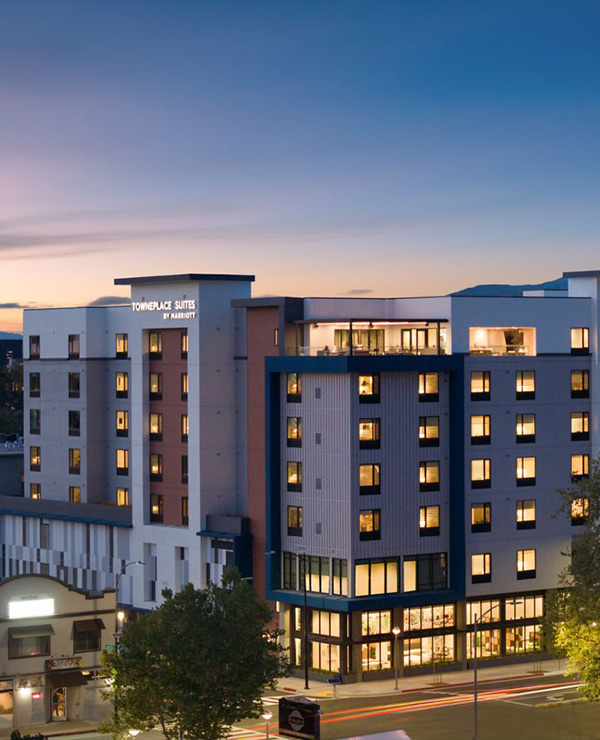 The Towne Suites Downtown San Jose viewed from the outside at dusk.