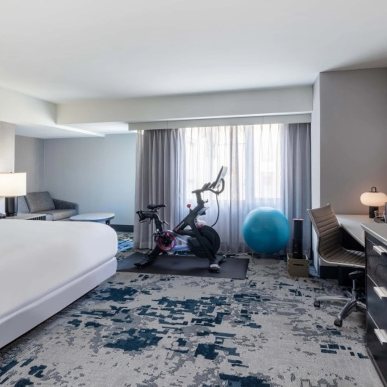 The interior of a room with an exercise bike at the Hilton San José.