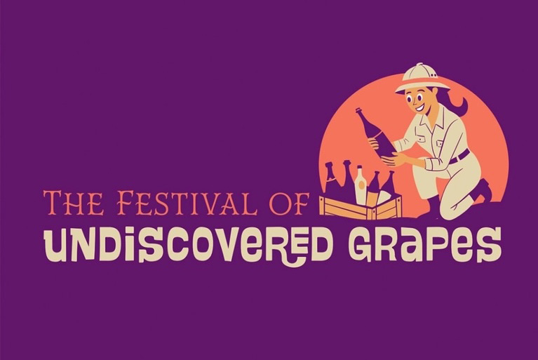 A cartoon graphic and logo showing a woman dressed as an explorer holding a bottle of wine. A headline reads: The Festival of Undiscovered Grapes.
