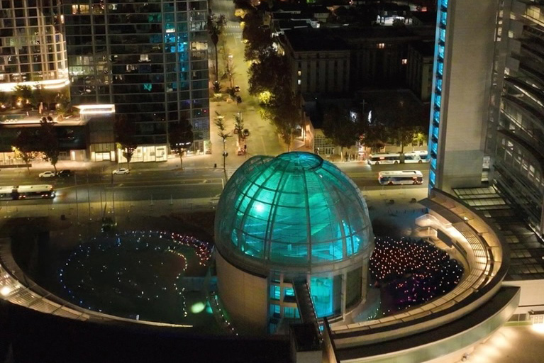 An aerial view of the San Jose City Hall at night.