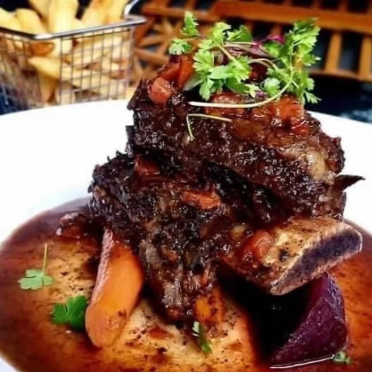 A delicious-looking gourmet short rib dinner.