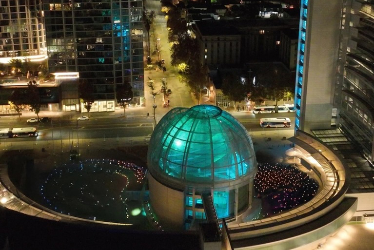 An aerial view of the San Jose City Hall at night.