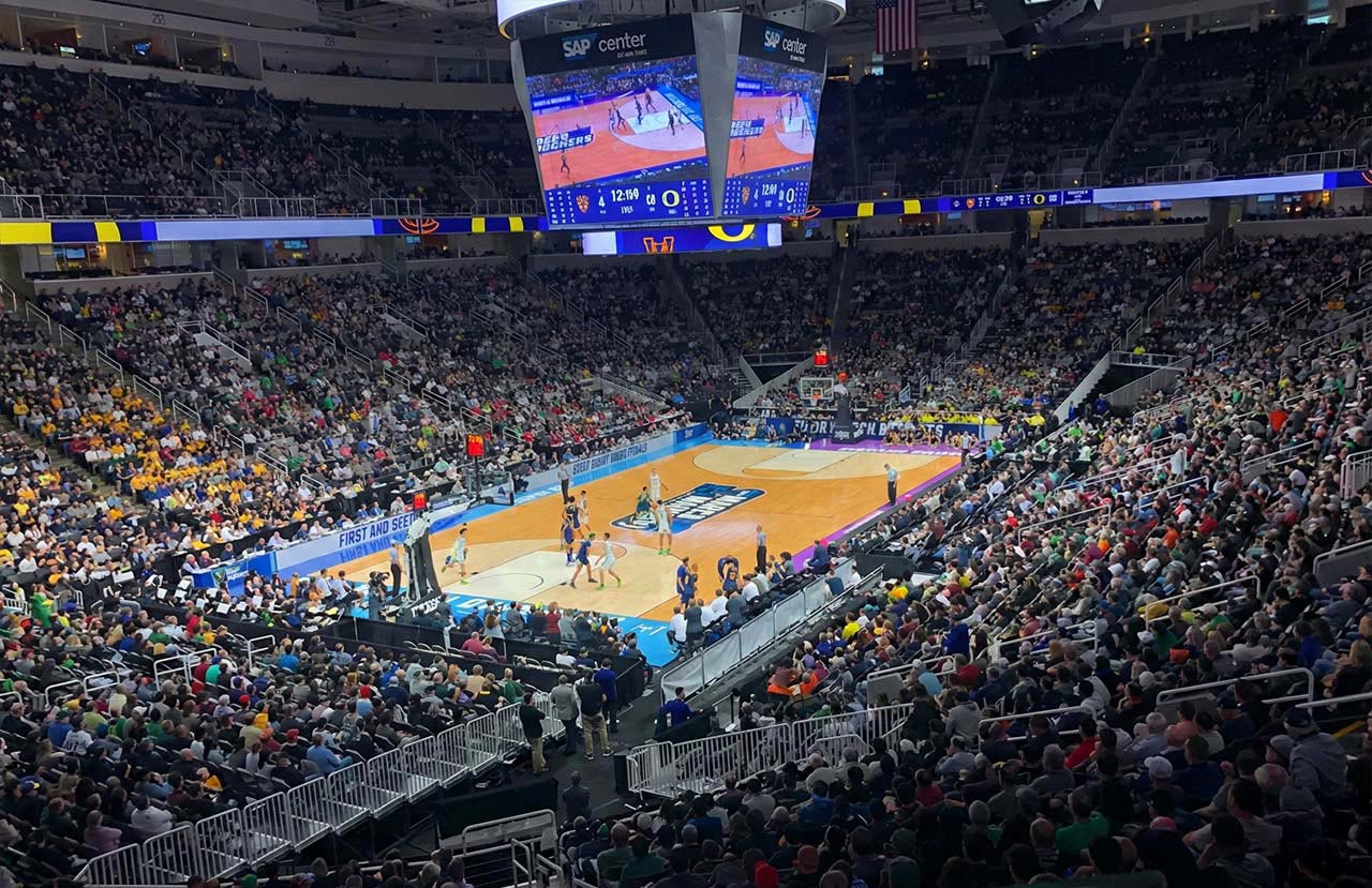Fans cheer as college basketball players compete during March Madness at SAP Center.