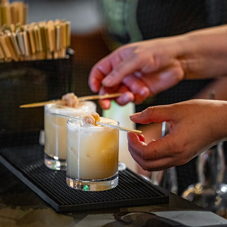 Small plate of seared scallops with herbs.