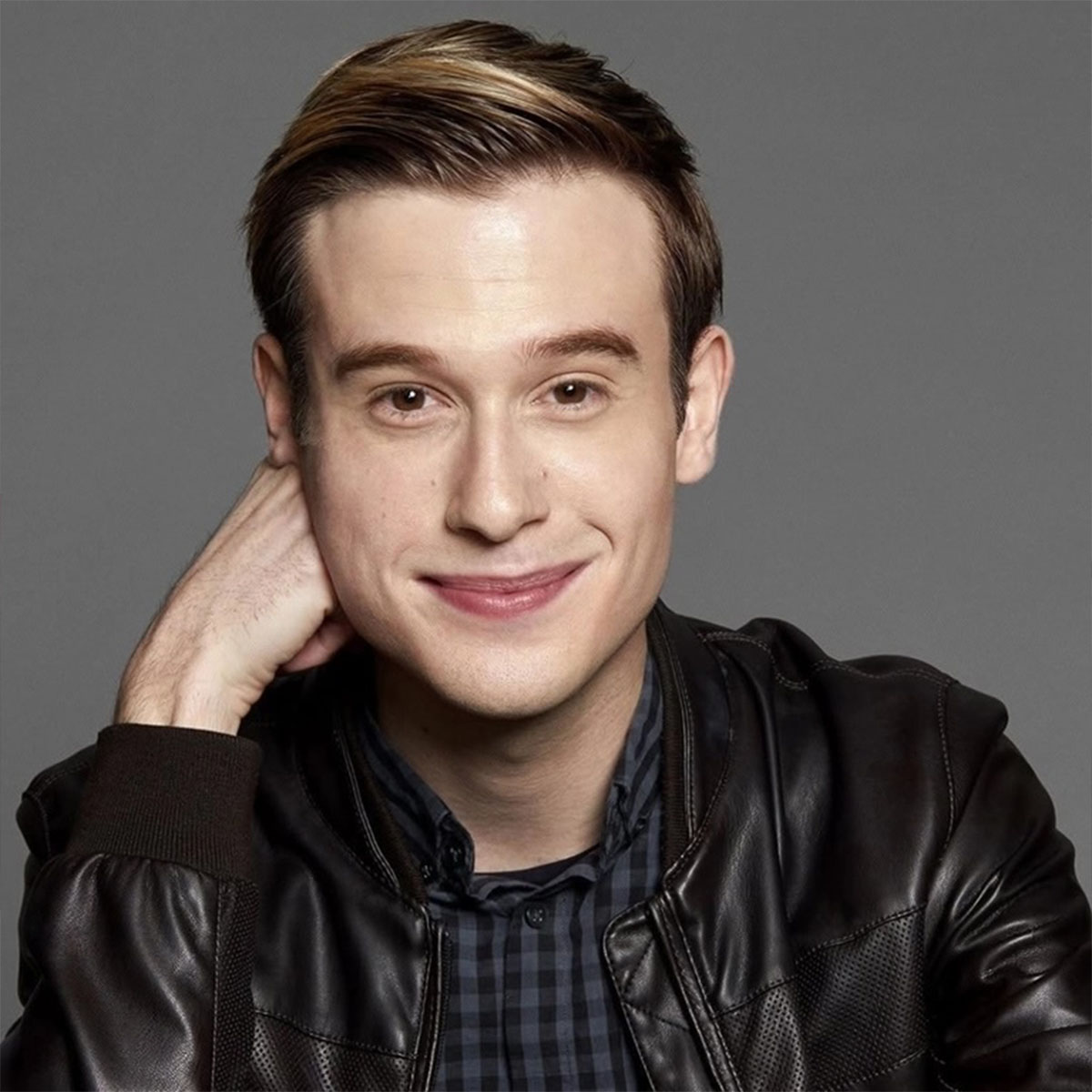 A professional headshot of Tyler Henry.