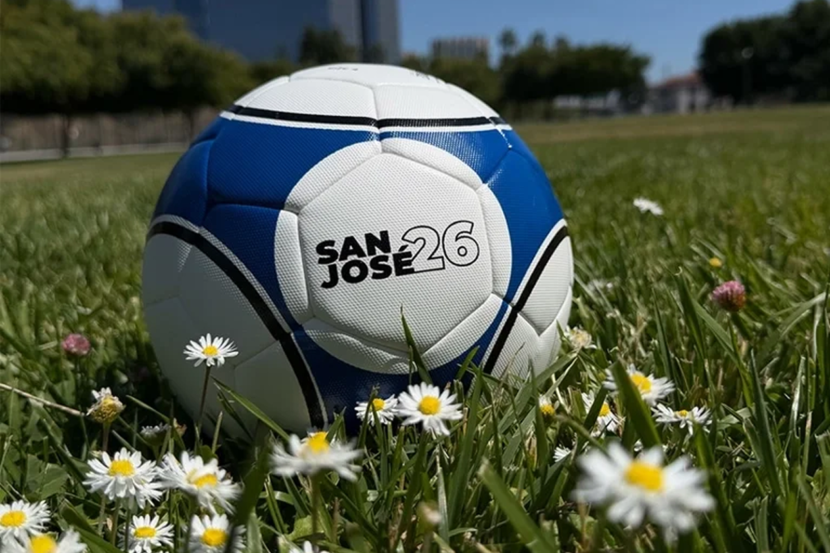 A soccer ball in a field that says San José '26