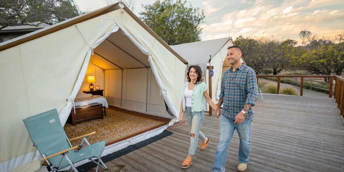Couple walking past tent