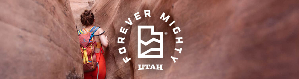 a woman hiking through a canyon in utah