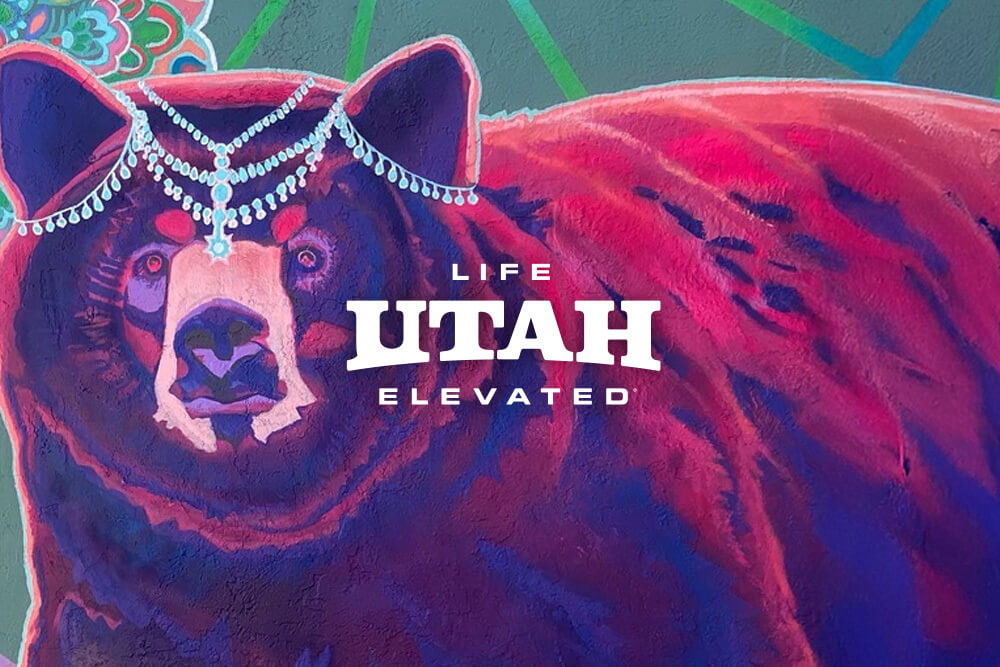 a painting of a purple bear wearing a beaded headdress