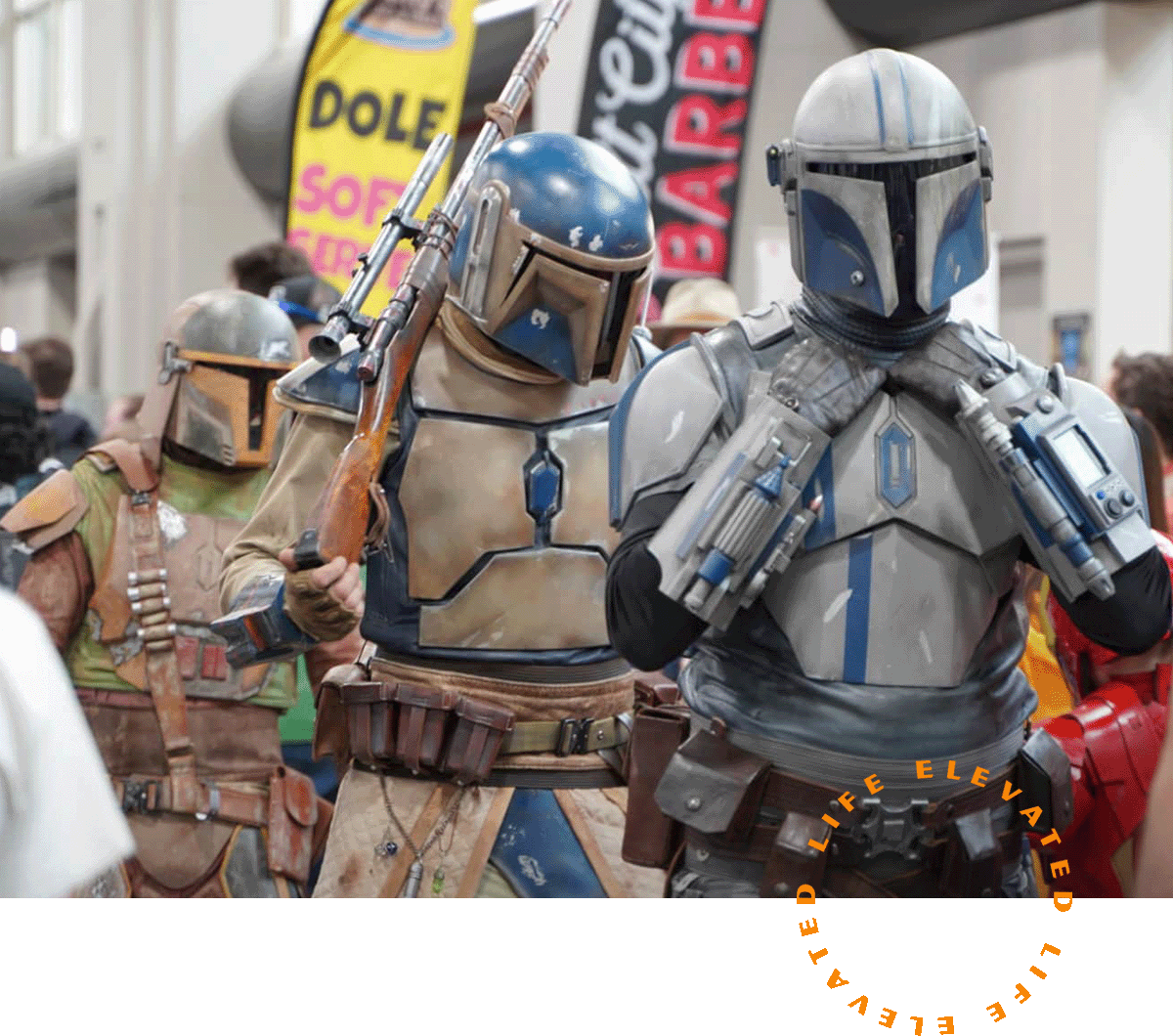 three people dressed as mandalorians at a convention