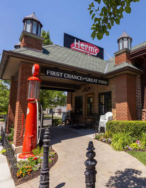 a restaurant with a red fire hydrant in front of it