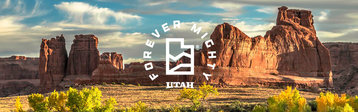 forever mighty overlaid on a rock formation in utah